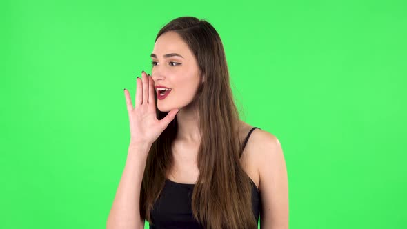 Girl Screams Calling Someone on a Green Screen at Studio