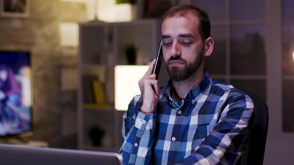 Overworked Businessman Yawn During a Conversation on Mobile Phone