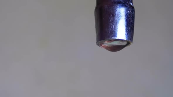 Water Driping From the Tap Into a Sink