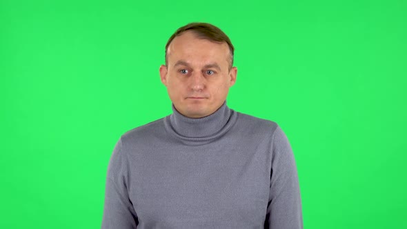 Portrait of Male Is Upset and Shrugs. Green Screen