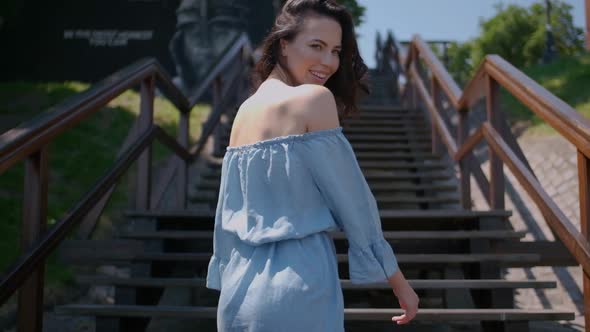 Beautiful Woman in Summer Fashion Dress Walking on Stairs in the Middle of City