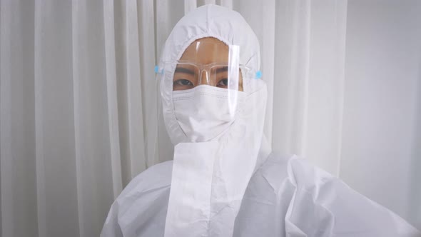 Medical Worker in Full PPE Kit Uniform with Hand Gloves During Covid19 Outbreak Swab Testing Patient