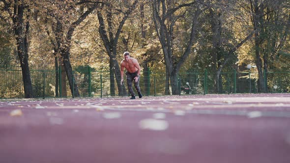 Healthy athlete is running in the stadium.