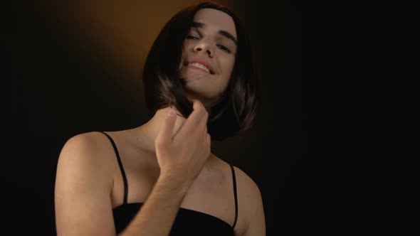 Trans Man in Wig and Dress Smiling Into Camera, Feeling Beautiful and Confident