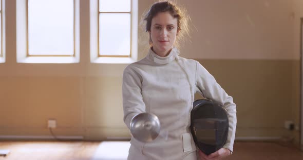 Female fencer athlete during a fencing training in a gym