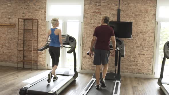 Man and woman exercising in gym