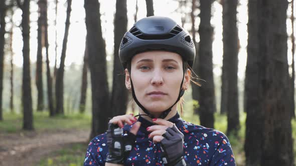 Cyclist puts on cycling helmet