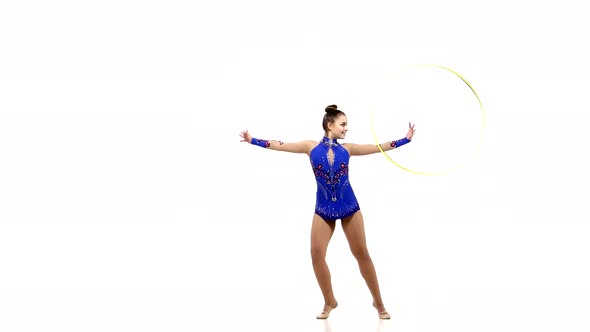 Outdoor Portrait of Young Beautiful Woman Gymnast with Hula Hoop