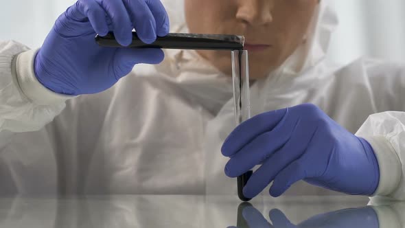 Lab Assistant Pouring Portion of Crude Oil Into Test Tube, Chemical Analysis