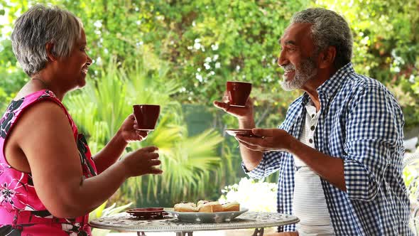 Senior couple having coffee at home