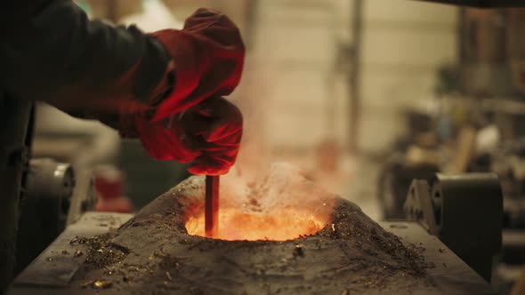 Foundry, Steel Industry, Worker Mixes Liquid Metal in Furnace, Flame, Remelting Steel