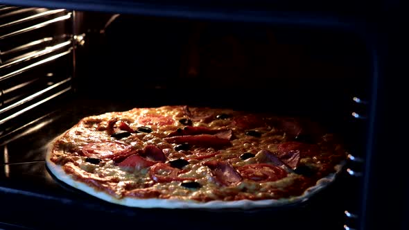 Cooking italian pizza in hot oven. Close-up timelapse of pizza. Rising pizza in oven