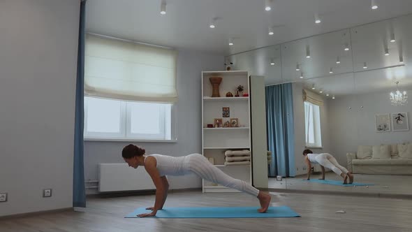 Young Woman Practicing Yoga in Studio