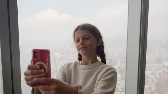 Girl Posing For Selfie With Smartphone In New York Skyscraper