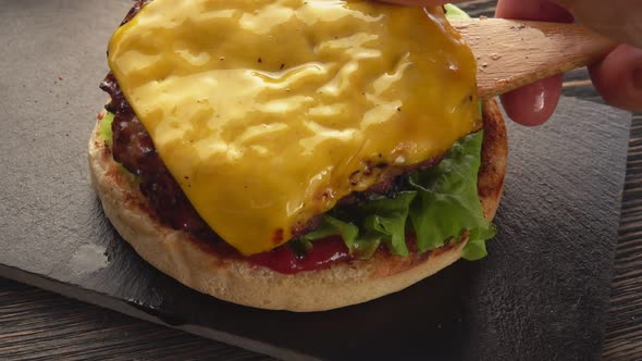 A Meat Cutlet with Cheese is Placed on the Top of the Homemade Grilled Burger