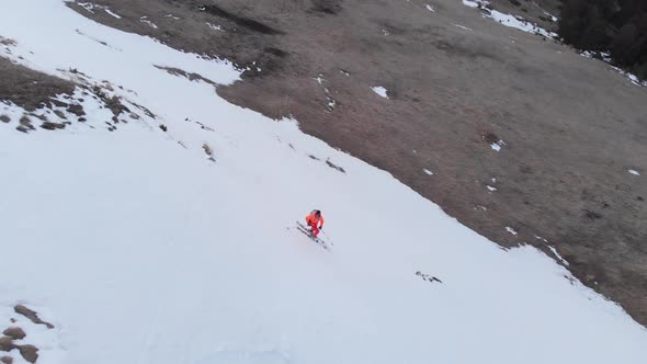 Aerial View of an Extreme Skier Rides on the Grass on a Slope Where There Is No Snow