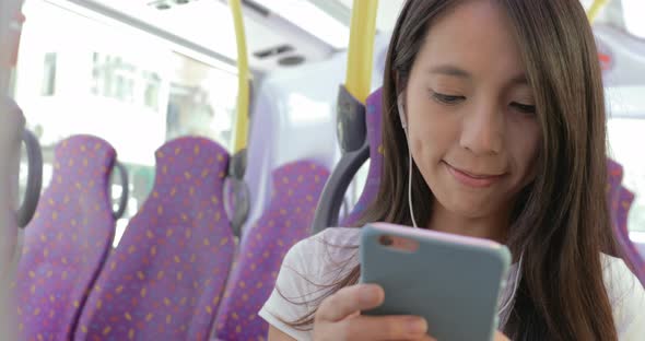 Woman use of mobile phone on bus in Hong Kong city