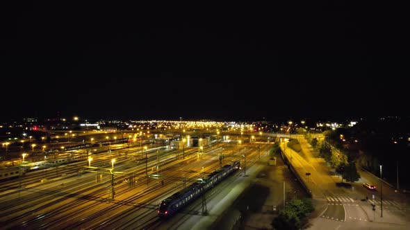 Aircraft following train leaving Malmö at night