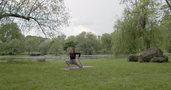 Young Fitness Woman Exercise in a Park in Summer