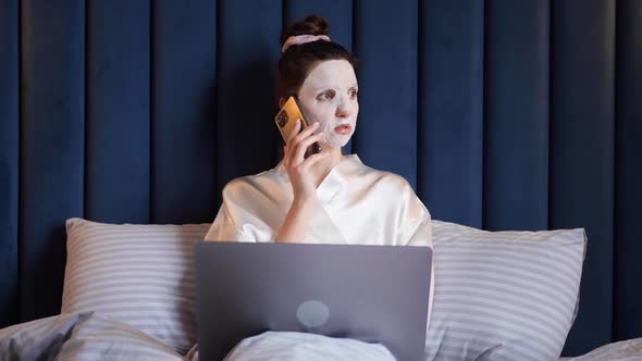 Young Woman Applies Cleansing Mask on Her Face