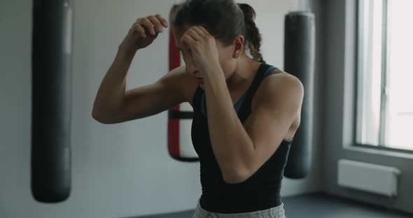 Mixed Martial Art Fighter Woman Does Shadow Boxing in the Fight Club Female Kickboxer is Fighting