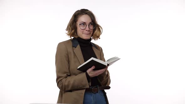 Smiling Beautiful Brunette Young Woman in Glasses and Brown Jacket Isolated Over White Background in