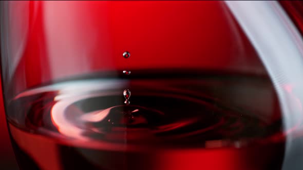 Super Slow Motion Macro Shot of Wine Drop Falling Into Red Wine in Glass at 1000Fps