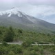 Person riding bicycle near snowcapped mountain, Chile - VideoHive Item for Sale