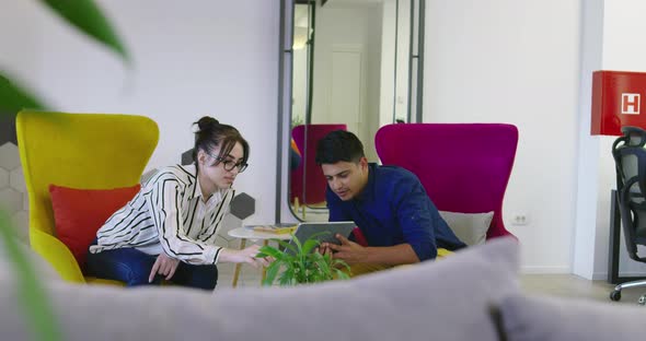 Stratup Company with Two People Using Tablet at Meeting