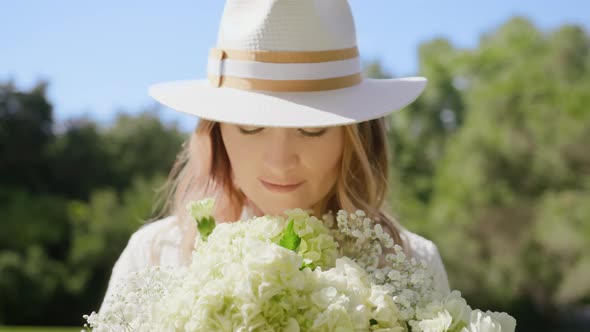 RED Camera Slow Motion Portrait Beautiful Woman Smelling Gentle White Flowers 6K