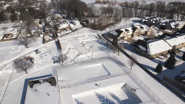 Aerial of closed outdoor Ice Rink due to covid lockdown on a sunny winter day