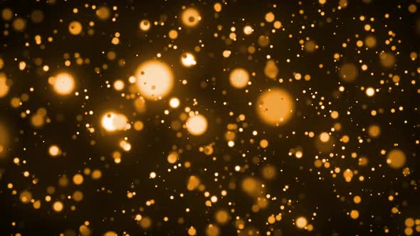 Animation of glowing gold spots of light moving in hypnotic motion on brown background