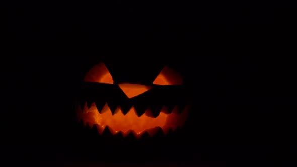Halloween Scary Glowing Pumpkin Face in Dark Closeup Horror Holiday Decoration