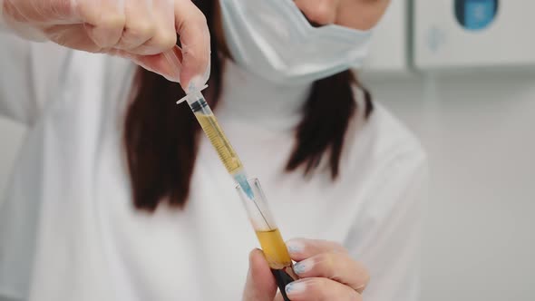 the Doctor Draws Blood Plasma Into the Syringe for Further Injection to the Patient