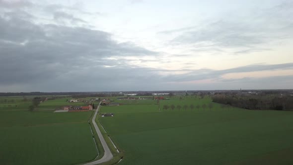 Flying Over Green Meadow with Small Trees