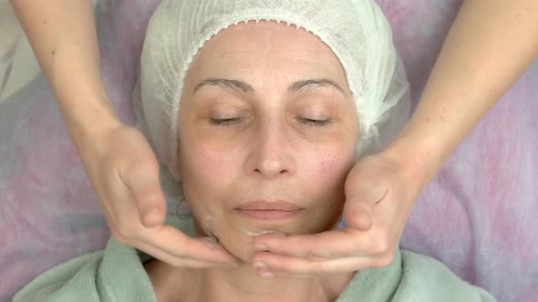 Cosmetician Applying Facial Gel Mask
