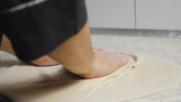 Close Up Male Arms of Cook Forming Pastry on a Wooden Surface at Cuisine