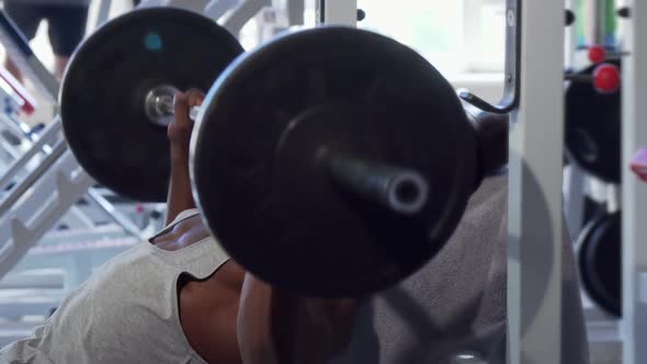 Ripped African Male Bodybuilder Smiling To the Camera After Lifting Barbell alt