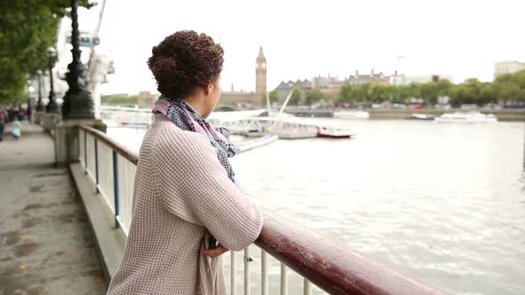 Mixed race woman taking a selfie in London with her smart phone