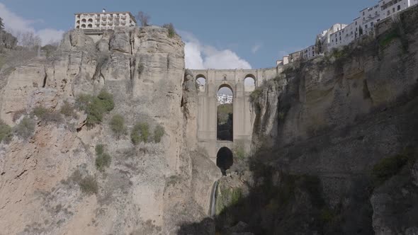 Aerial view of dramatic medieval arch bridge over gorge in Ronda Spain