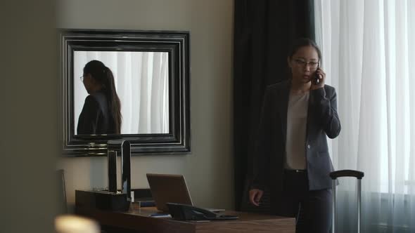 Asian Businesswoman Talking on Phone in Hotel