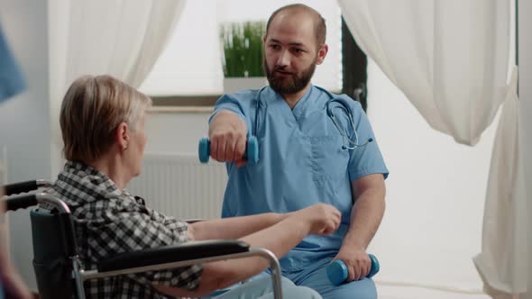 Medical Assistant Giving Assistance to Disabled Old Woman