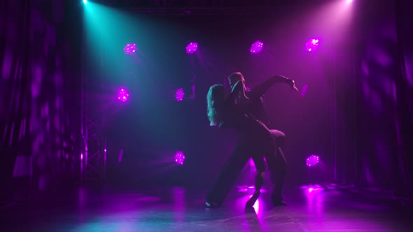 Rumba Performed By a Young Graceful Couple. Silhouettes of Dancing Partners Against a Background of