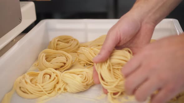 Man Making Fresh Pasta on Traditional Italian Kitchen Machine for Spaghetti Chef Preparing Fresca