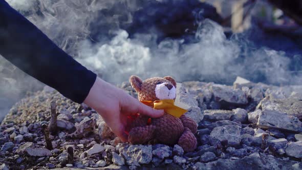 Concept Idea of the Victims of the Disaster ,The Female Hand Puts a Toy in Honor of the Memory of