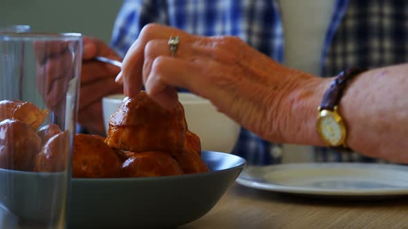 Senior friends having breakfast on dining table 4k