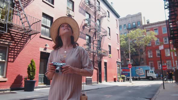 Young girl with a retro camera in New York