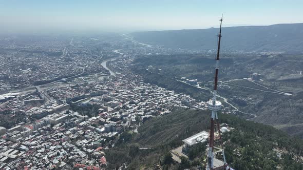 Aerial view of TV Tower in Mtatsminda park. Against the background of the city. Tbilisi, Georgia