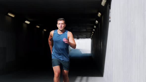 Young Man Running Out of Tunnel