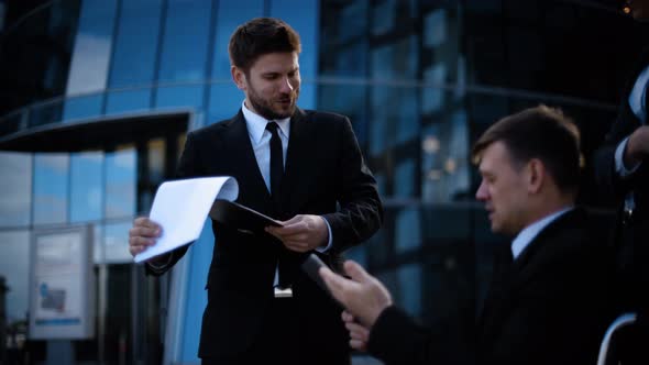 Business People with Handicapped Colleague Have Deal Conversation Outdoor